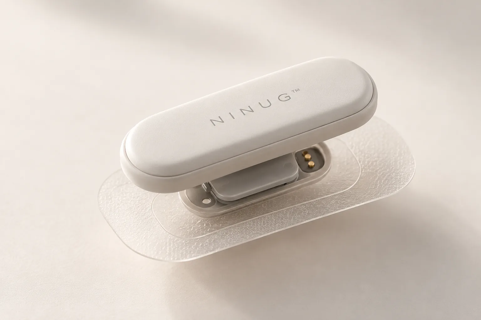 The Ninug patch separated into its reusable pod and adhesive base, showing the gold contacts