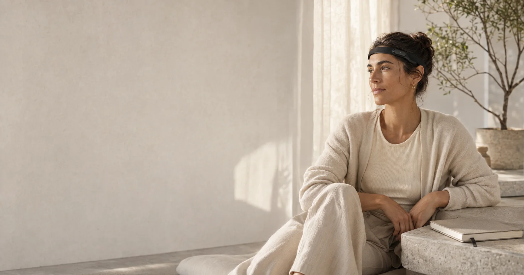 A person sitting quietly at home wearing the Ninug band